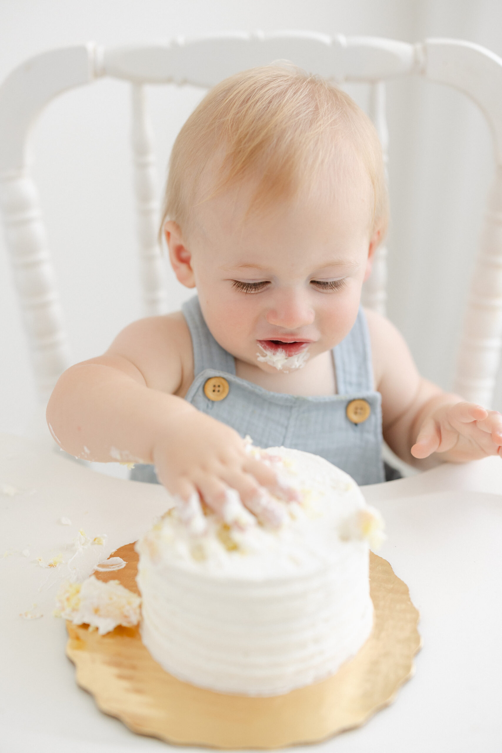 on year old eating cake